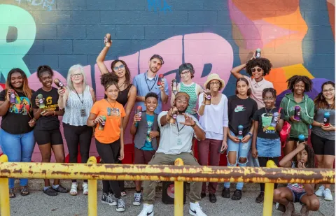 People in front of mural